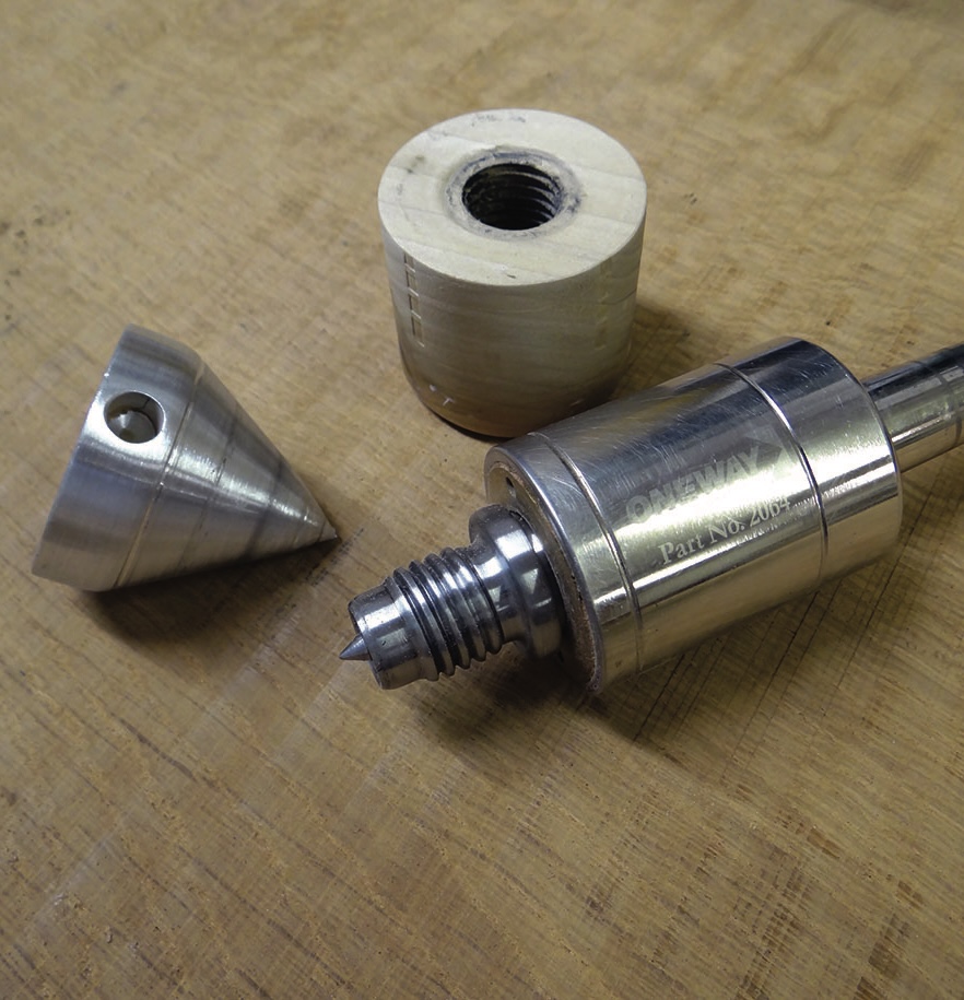 Metal threaded tool parts on a wooden workbench