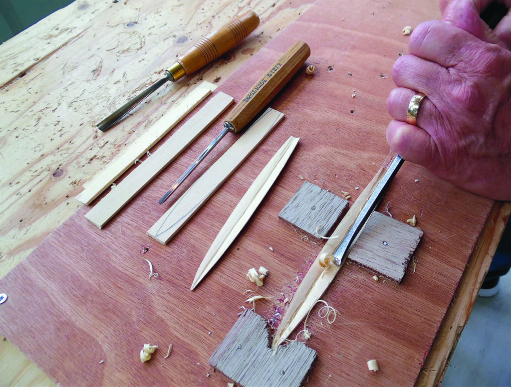 Woodworker carving a wooden clothes peg on a bench