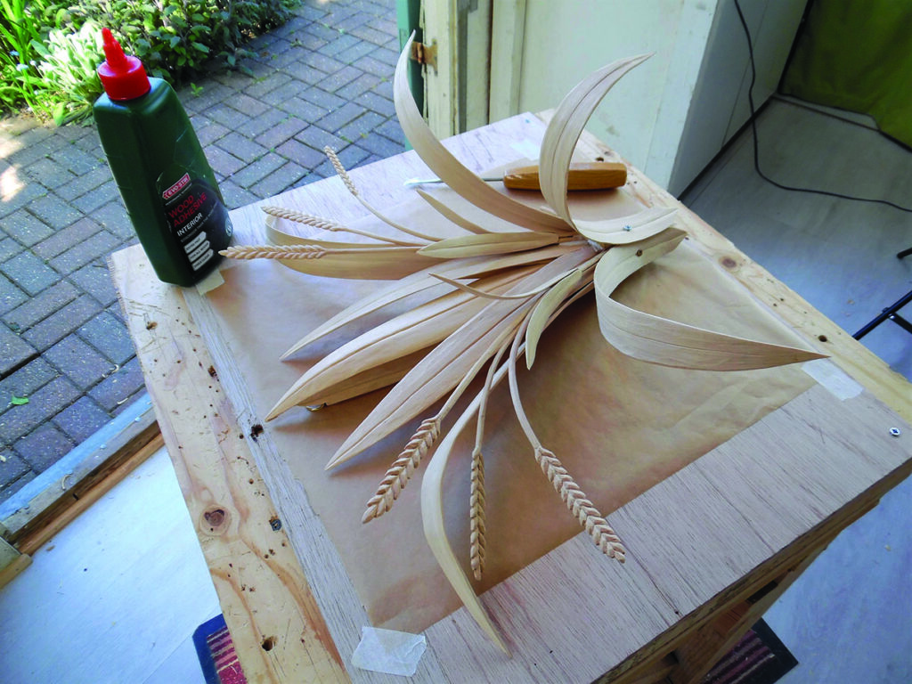 Handcrafted wooden floral arrangement beside wood adhesive