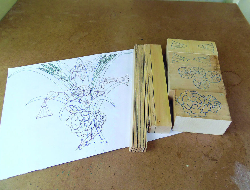 Floral line drawing beside carved wooden printing blocks