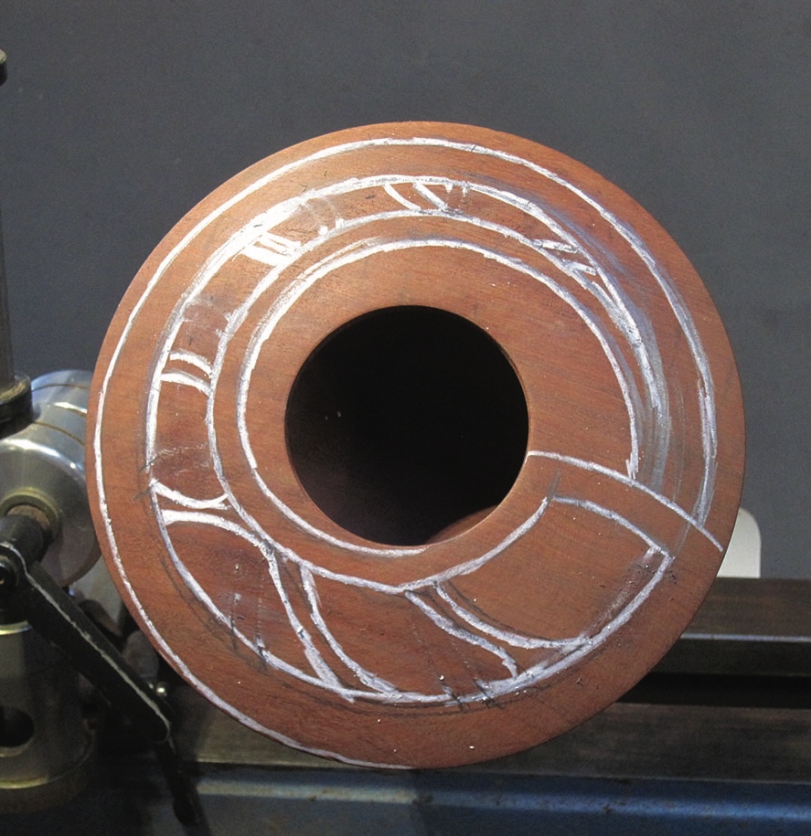 Wood on lathe with white carved lines