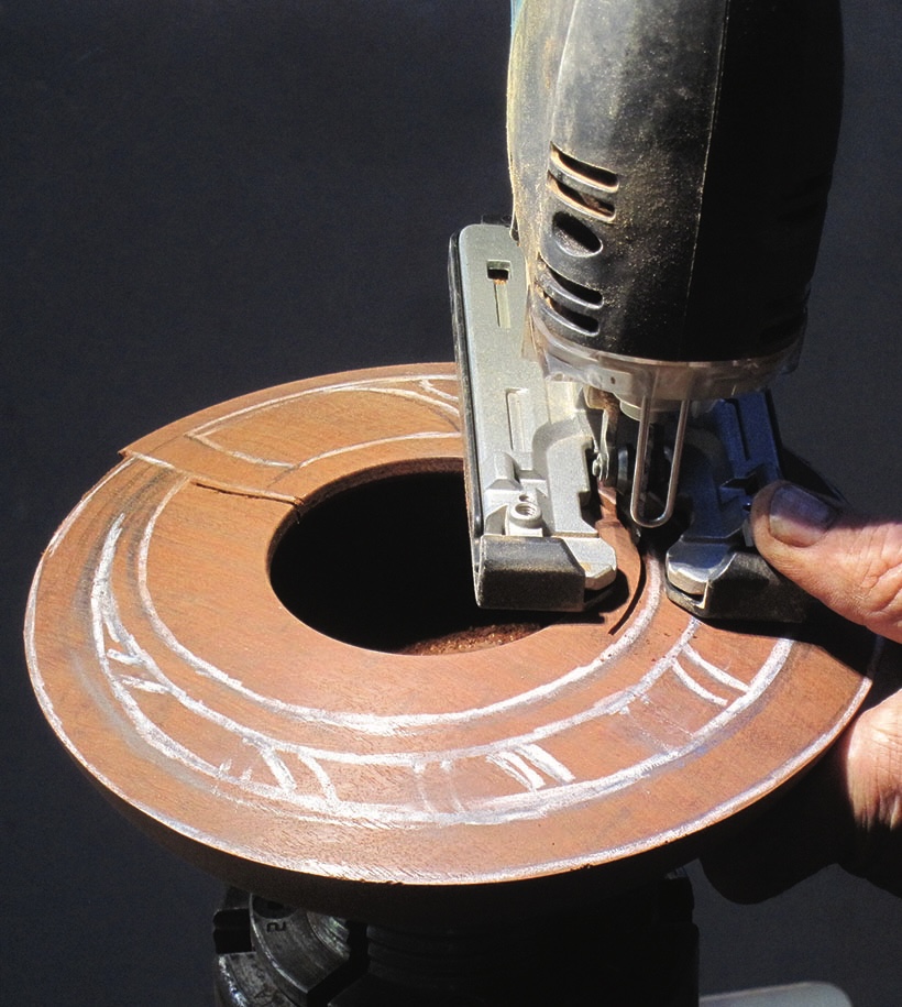 Jigsaw cutting circular wooden piece precisely.