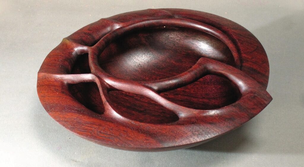Intricate carved wooden bowl with natural design.