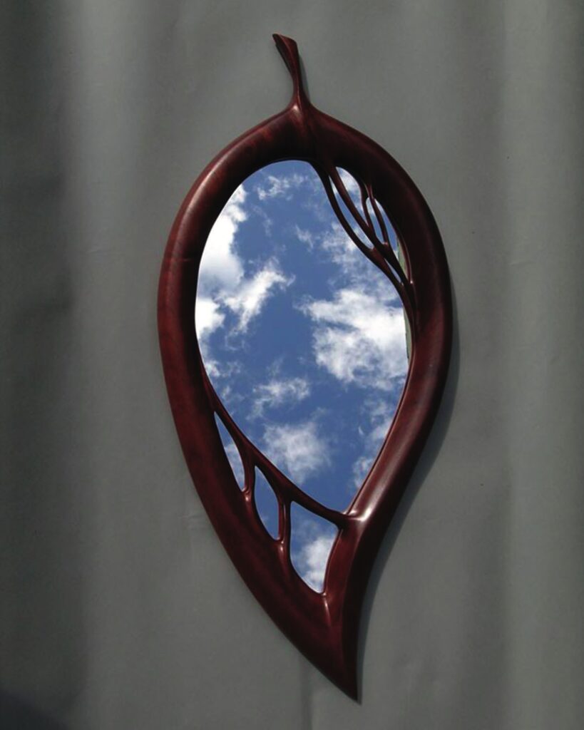 Leaf-shaped mirror with sky reflection
