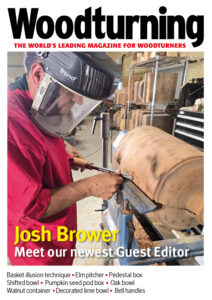 Woodworker turning large wooden piece on lathe.