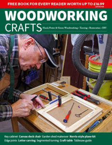 Person working on woodworking project in workshop.