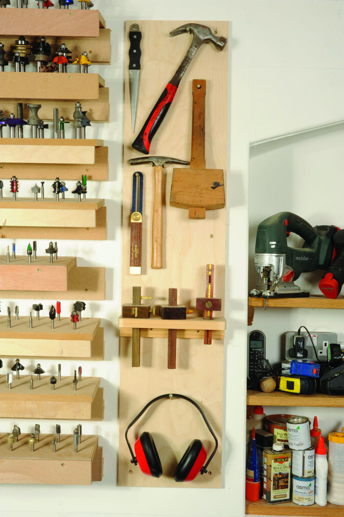 Organised workshop tools, shelves, and safety equipment.