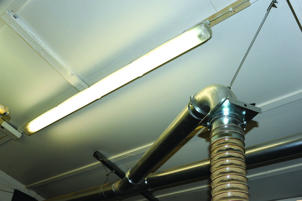 Ceiling with fluorescent light and ventilation duct.