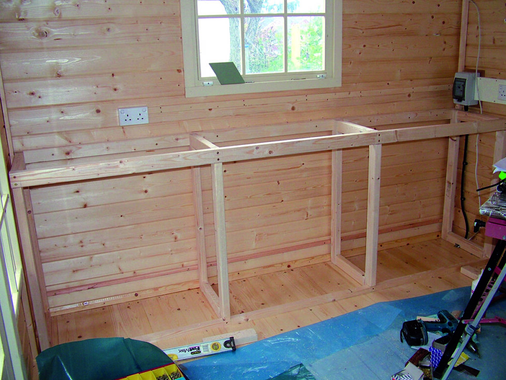 Wooden framework construction inside a wooden shed.