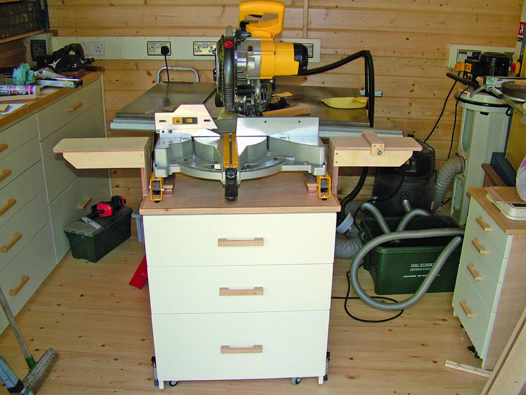 Workshop with power tools and wooden cabinets.